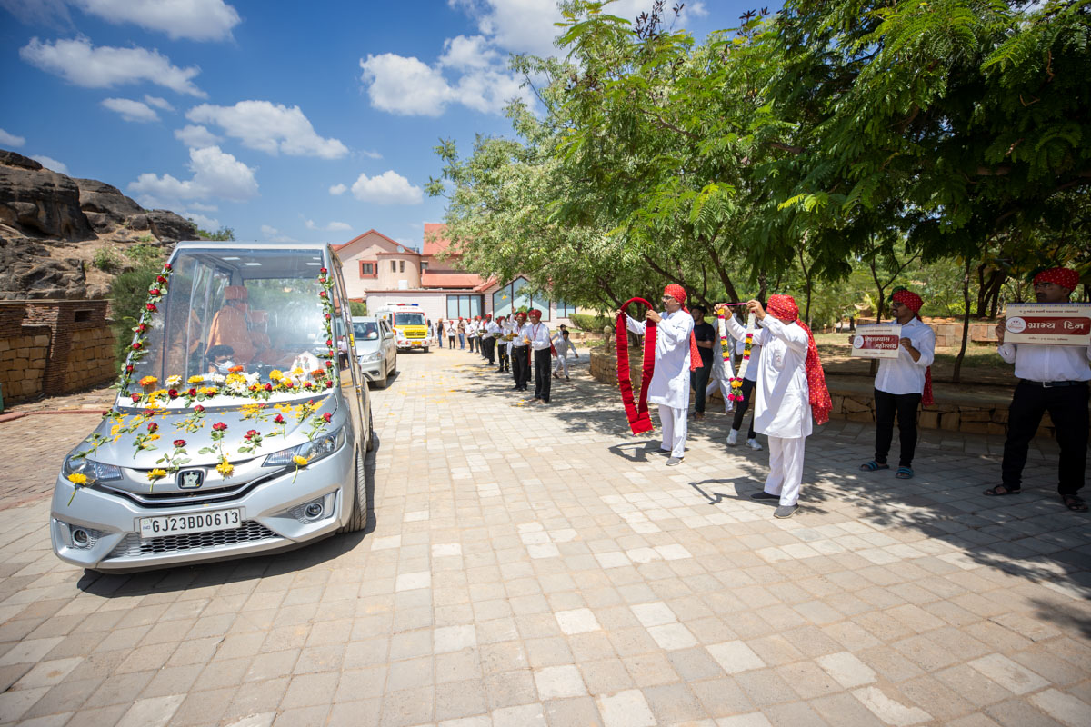 Devotees welcome Swamishri with garlands