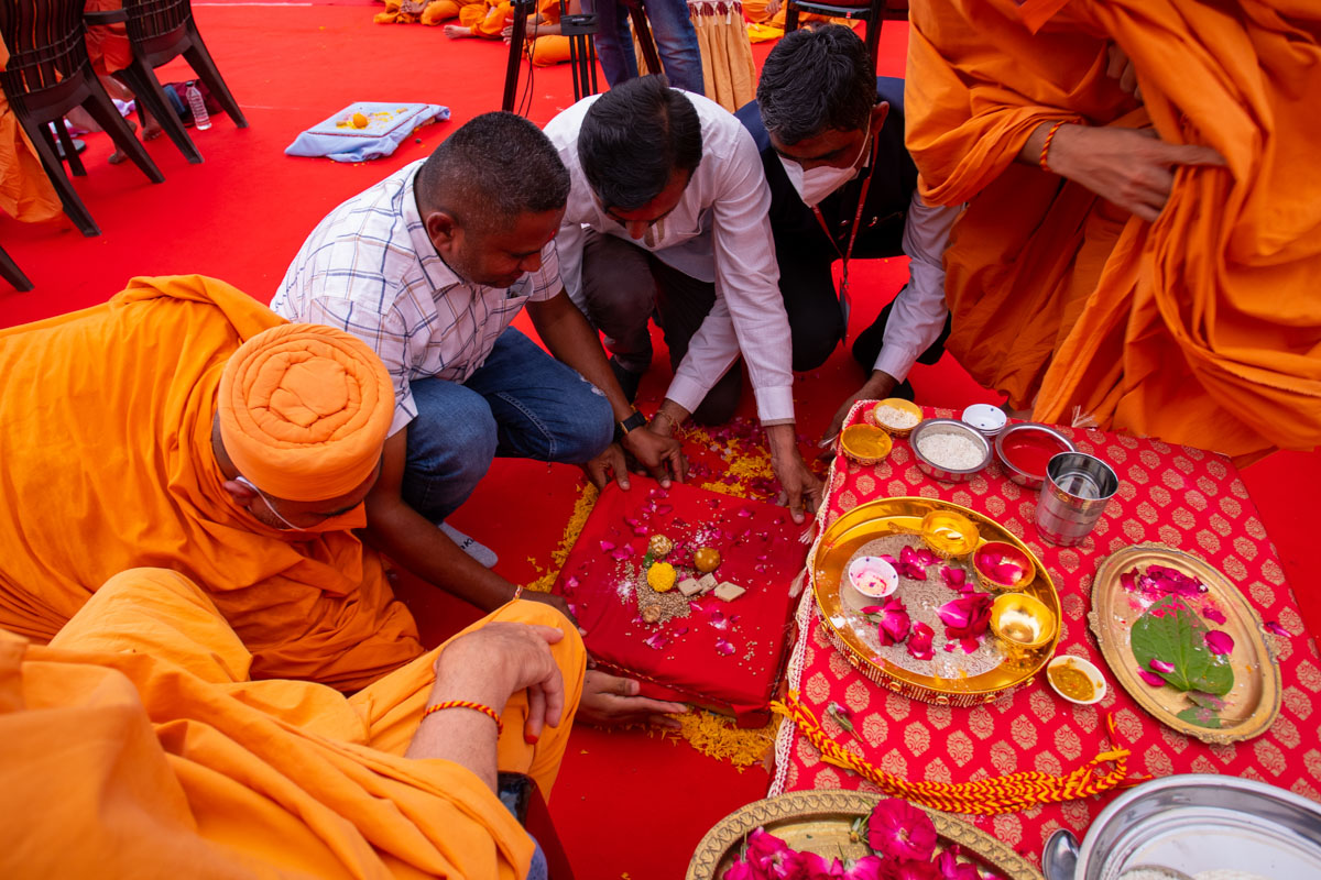 Sadhus and devotees place a shila