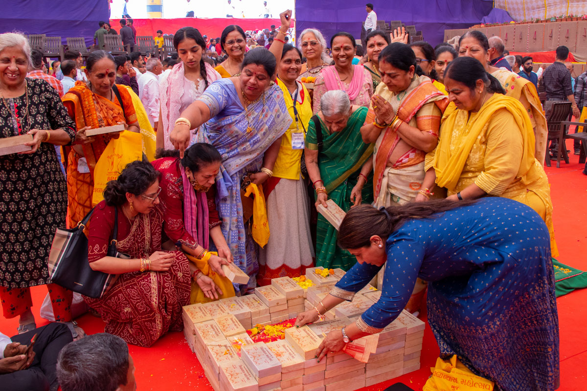Devotees and well-wishers place bricks in the foundation