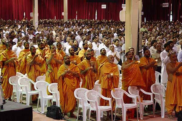 Saints and devotees perform aarti 