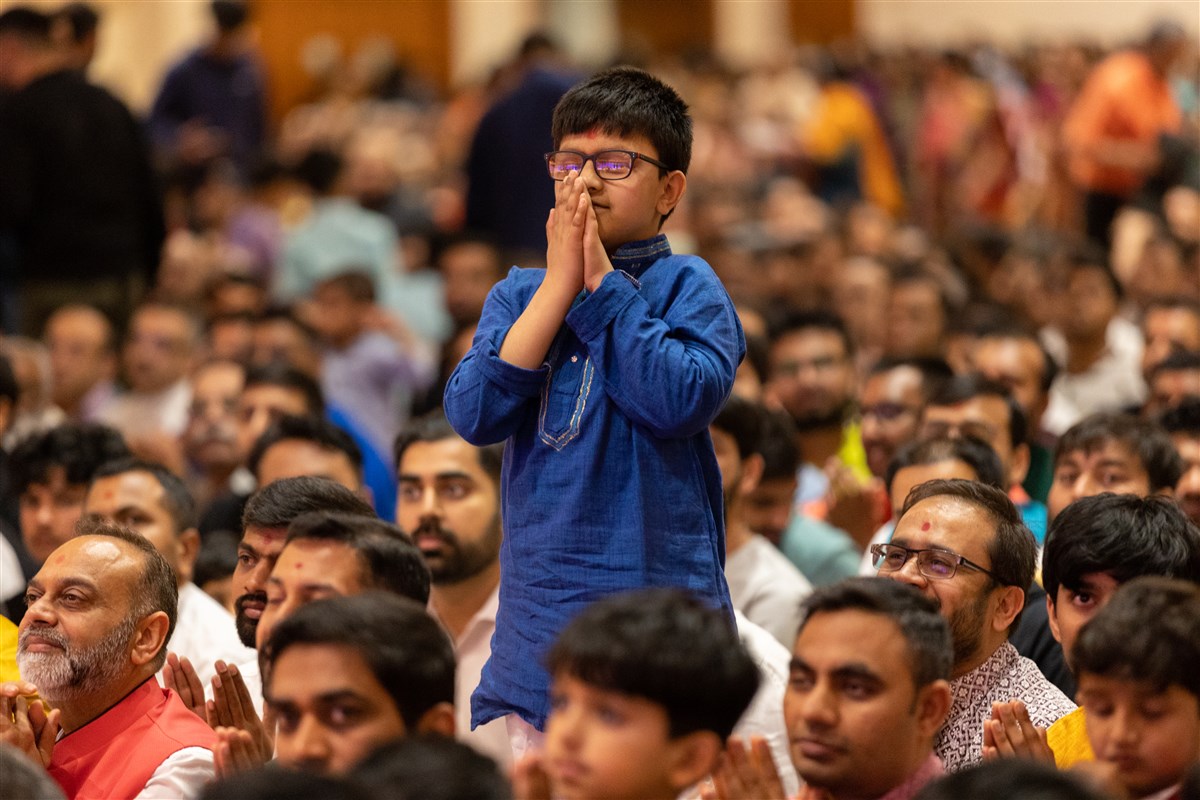 A young devotee engrossed in Swamishri's darshan