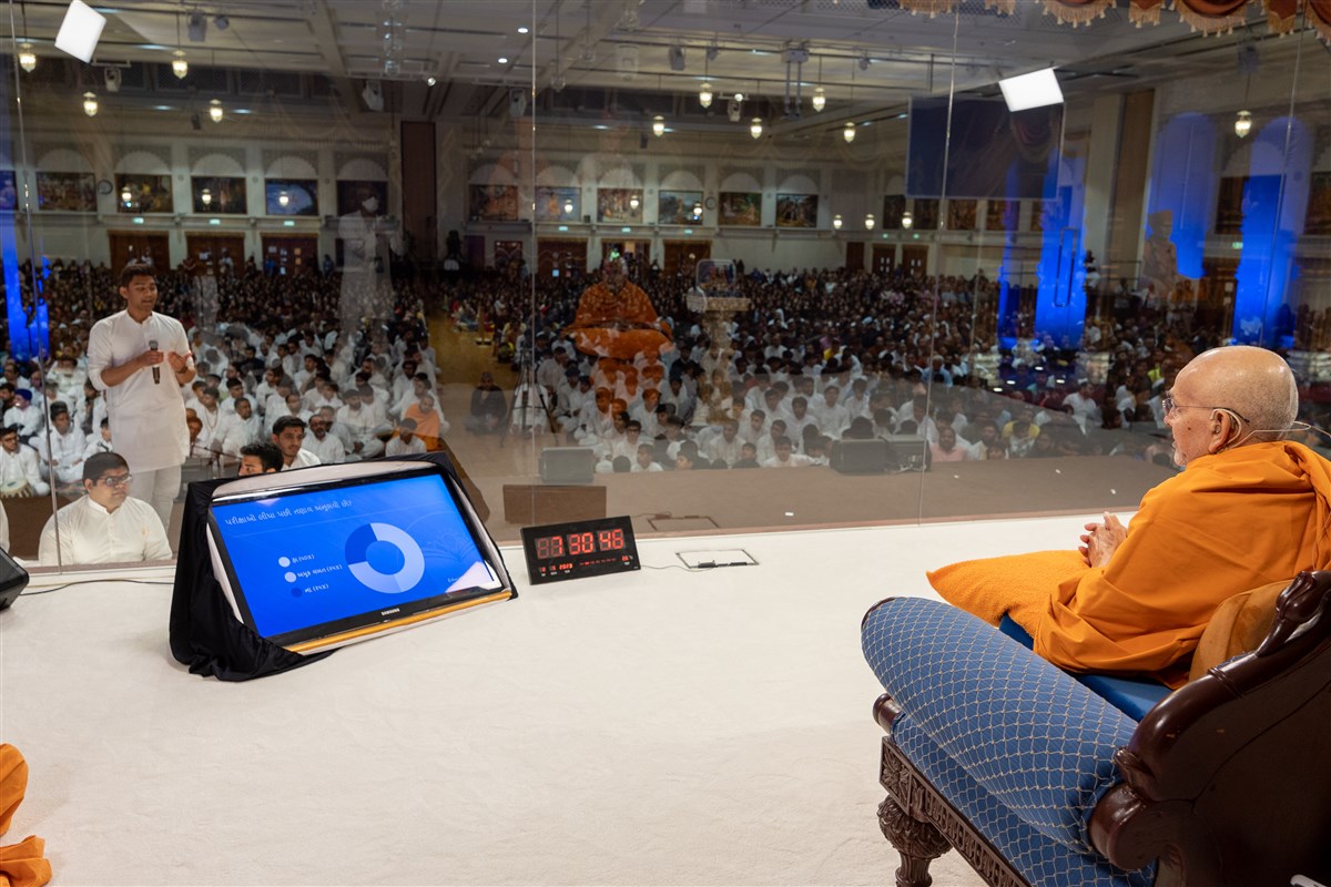 Swamishri listens as a youth narrates the situation for kishores and kishores as exams approach