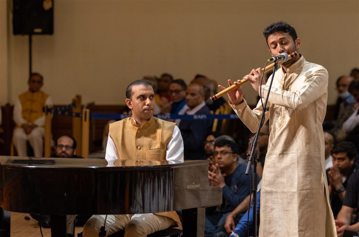 Praveen Prathapan, on the Indian flute, and Rekesh Chauhan, an acclaimed British Indian pianist, perform in Swamishri's morning puja