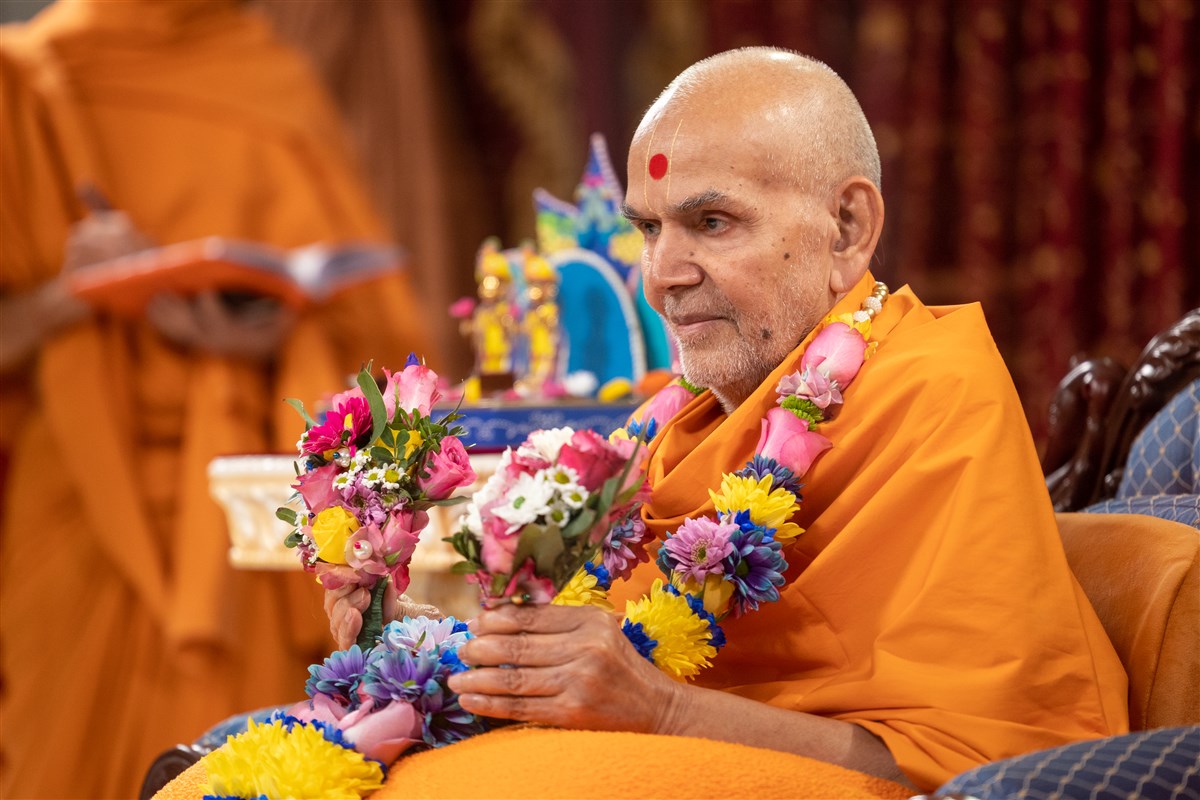 Swamishri adorning the garland and posies