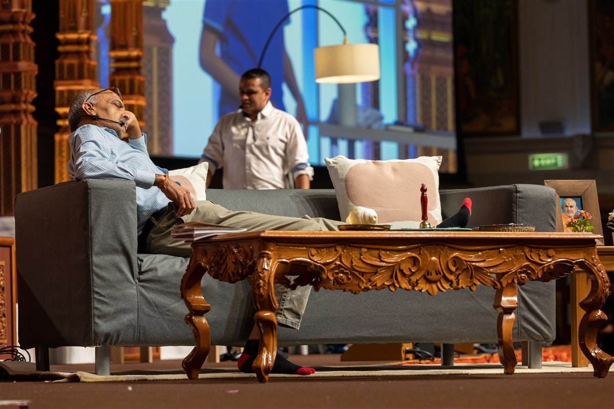 ...while Dada, Akshar's grandfather, napped on the sofa,...