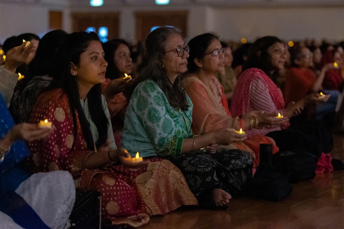 Devotees join in the evening arti