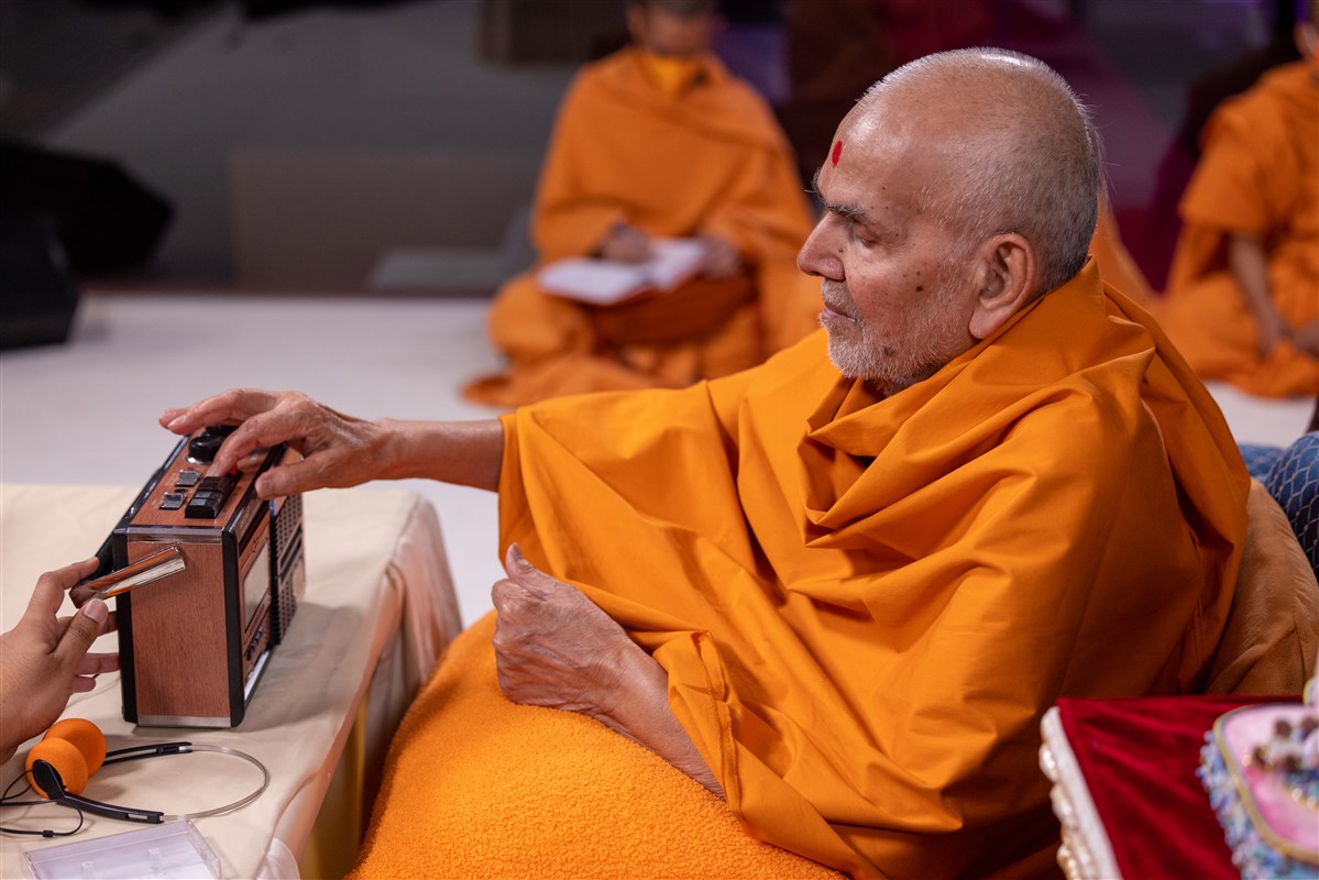 Swamishri presses 'play' on the cassette player, which activates the sound of Yogiji Maharaj revealing his spiritual successors, Pramukh Swami Maharaj and Mahant Swami Maharaj