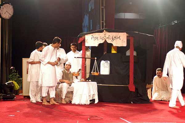 Youths perform a humorous drama in the presence of Swamishri