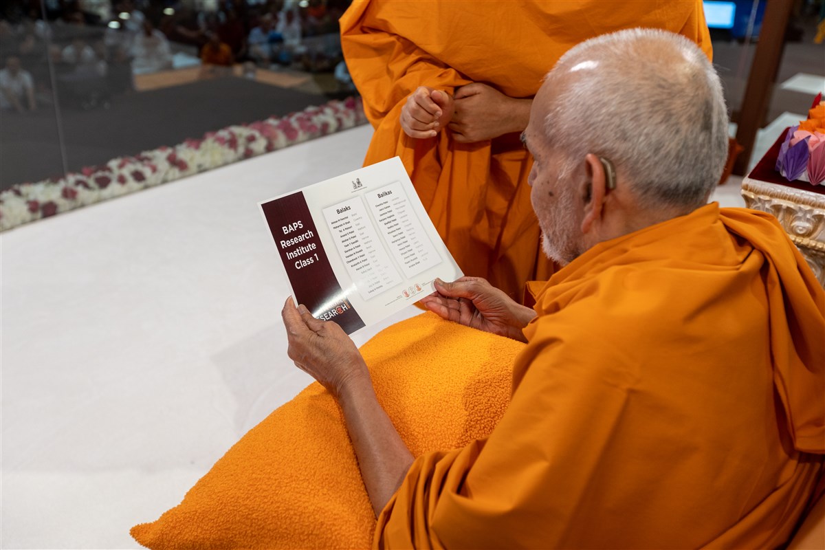 Swamishri blesses the names of children who comprise the inaugural class of students for the BAPS Swaminarayan Research Institute in London
