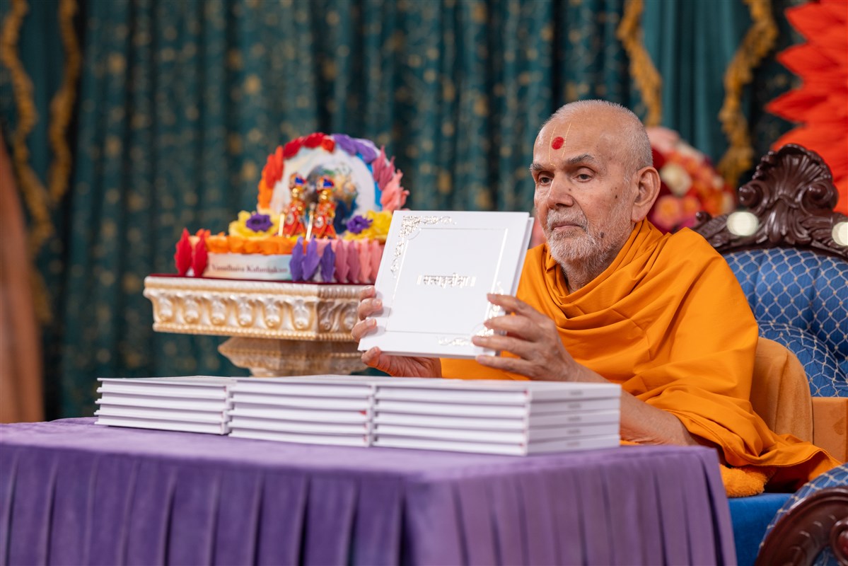 Swamishri blesses special copies of the Satsang Diksha for those who memorised all 315 verses