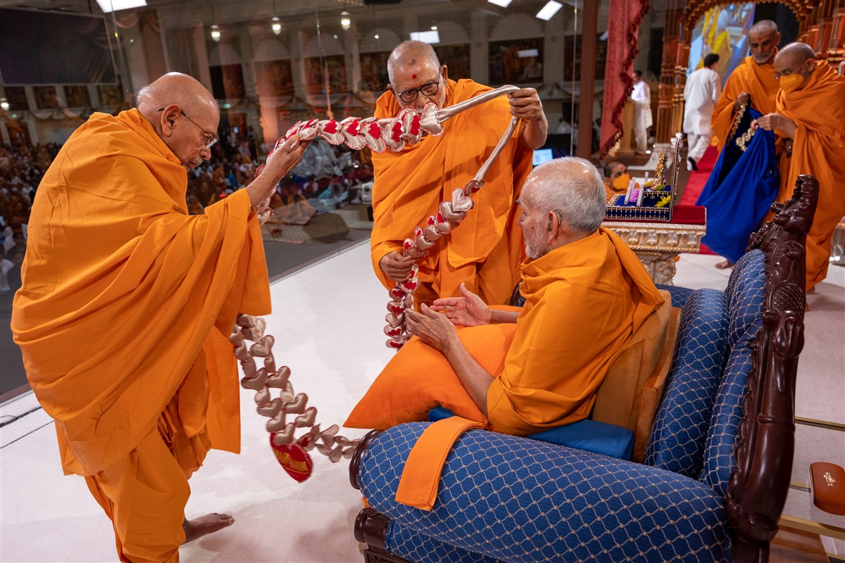 Pujya Kothari Swami and Pujya Tyagvallabhdas Swami honour Swamishri with a decorative garland