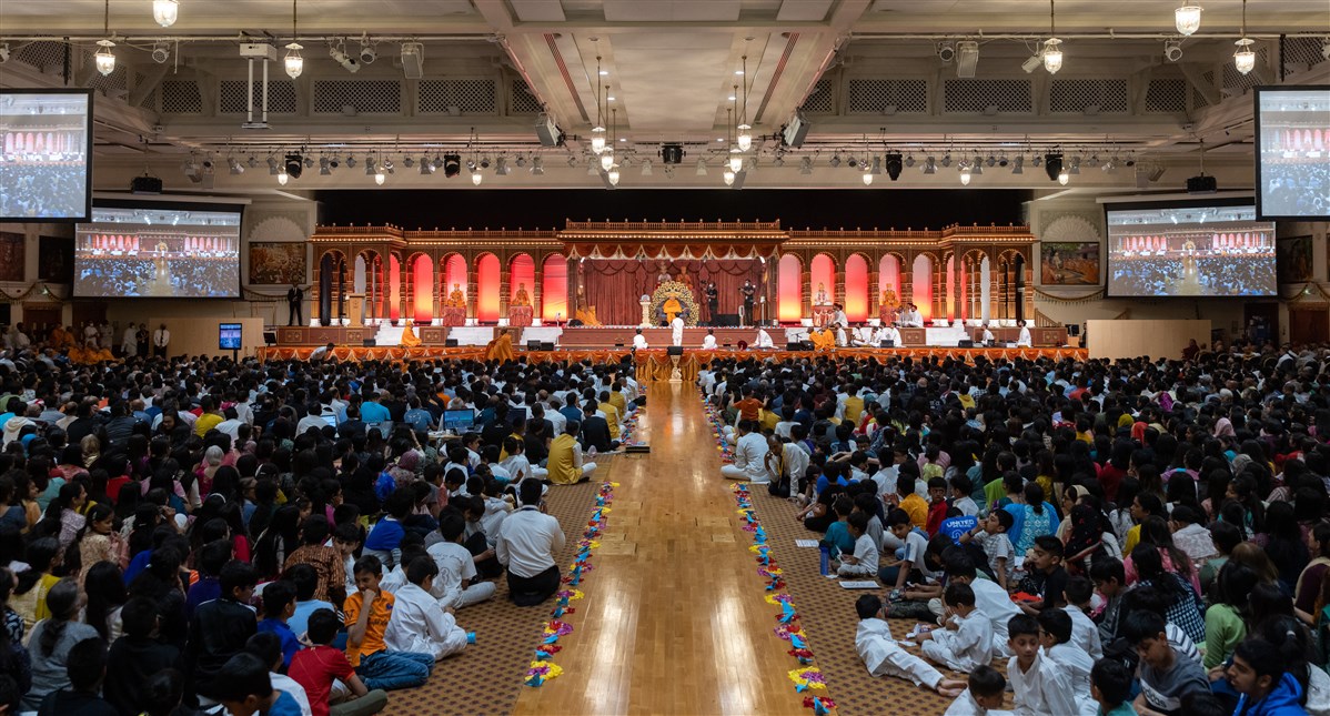 Devotees in the assembly join in prayer to Swamishri