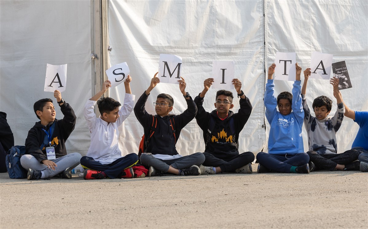 In a symbolic representation of Asmita Din, the children loftily hold up letters spelling 'Asmita'
