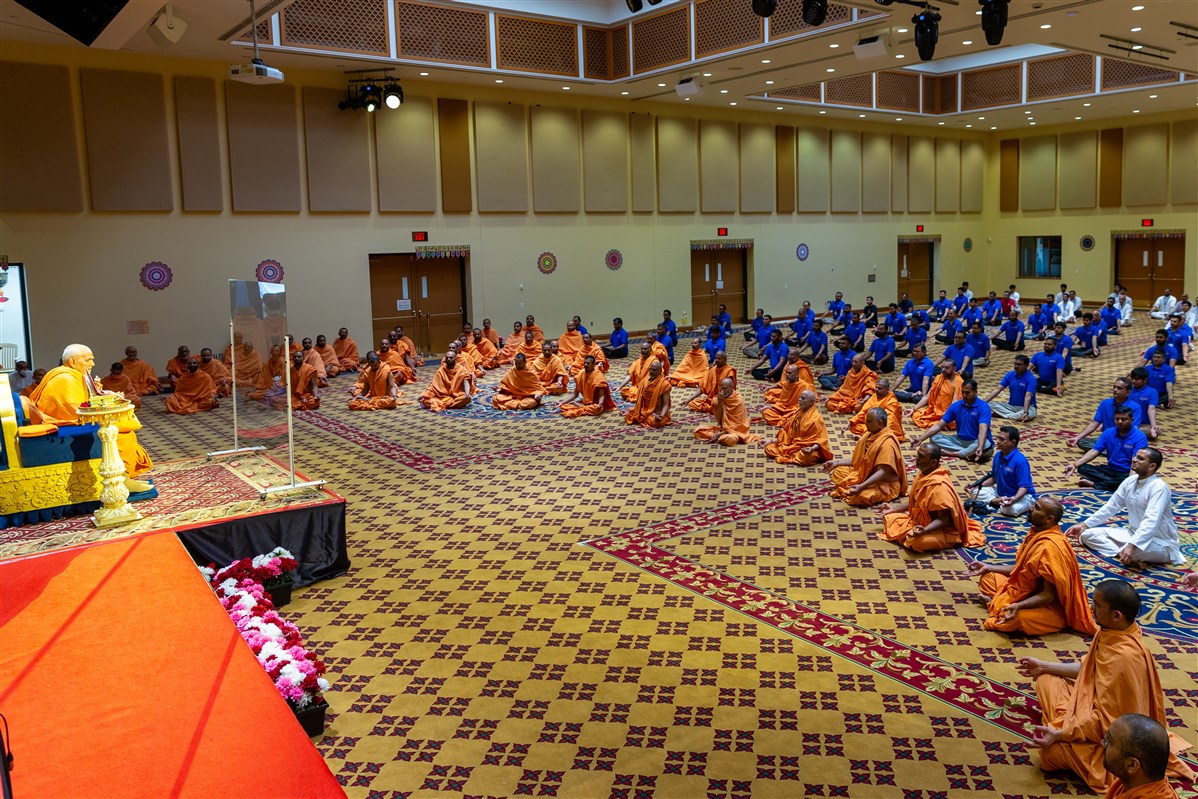 Swamishri, along with Swamis and devotees, practice yoga in observance of the International Day of Yoga