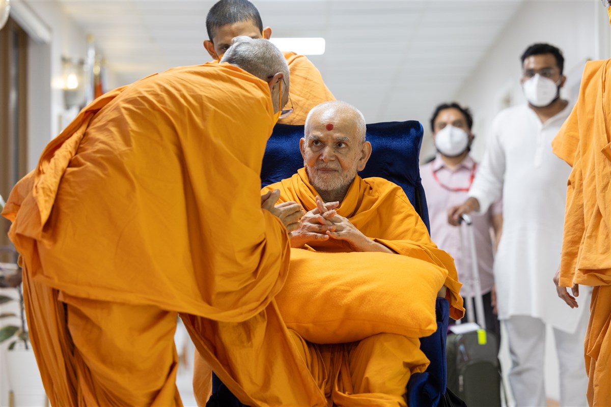 Swamishri listens attentively to a swami