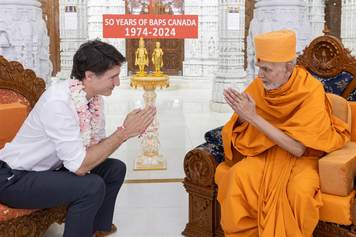 Swamishri and Prime Minister Trudeau greet each other with folded hands