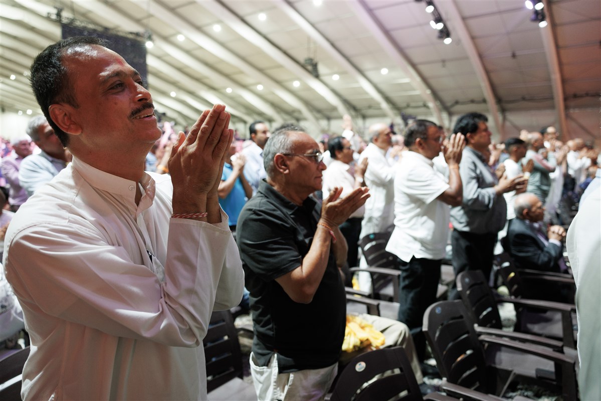 ..Devotees respond with folded hands