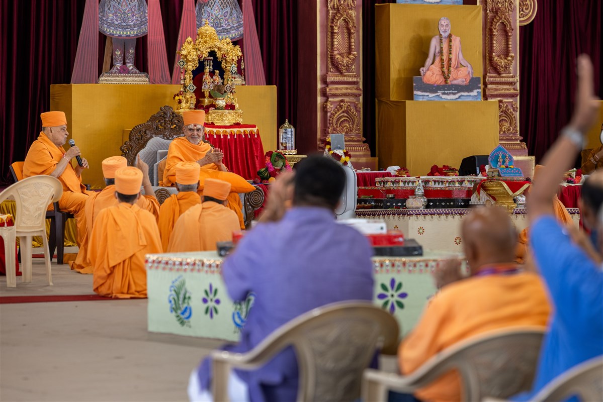 Swamishri shows his appreciation by clapping while Sadguru Ishwarcharandas Swami addresses the assembly