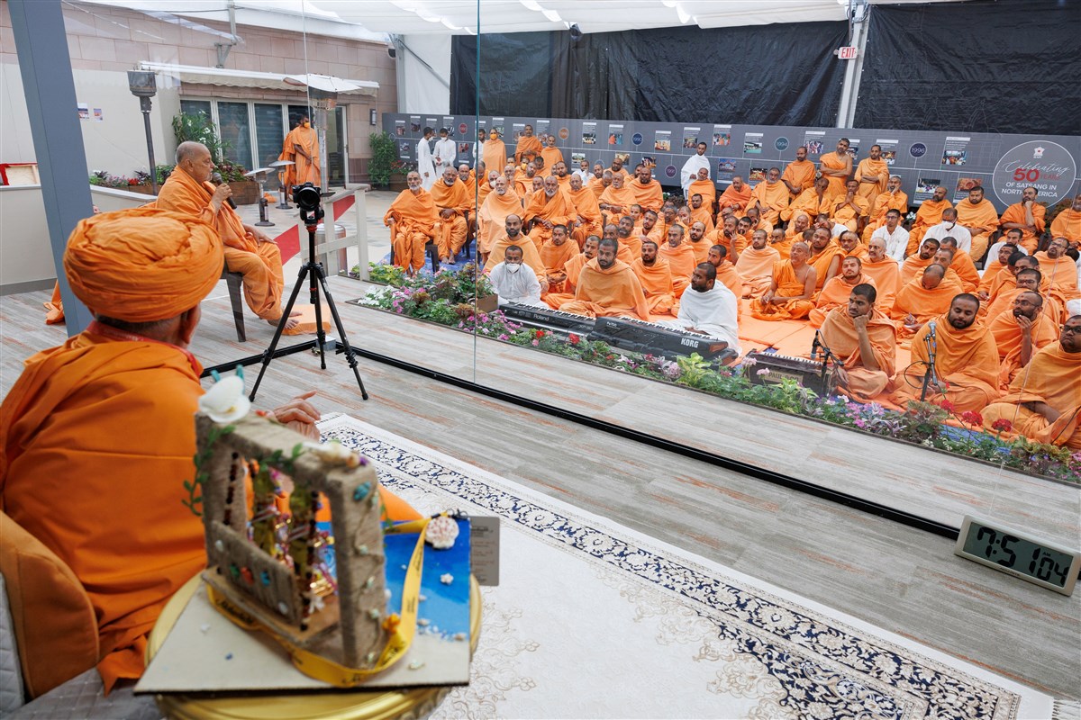 Swamishri listens attentively to Sadguru Ishwarcharandas Swami
