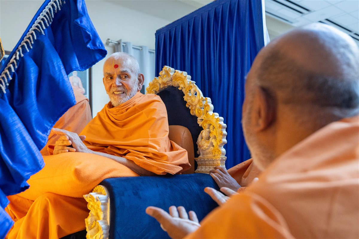 Swamishri interacts with a swami