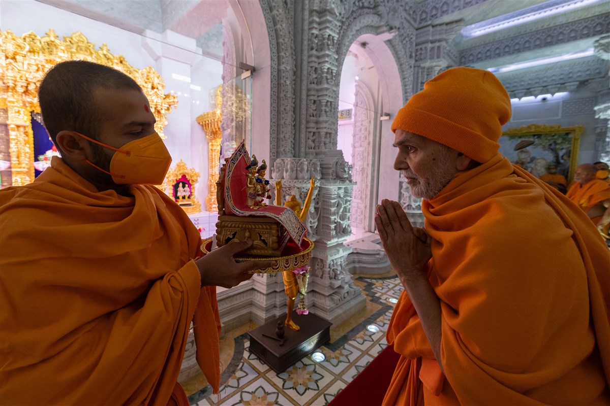 Swamishri engrossed in the darshan of Shri Akshar Purushottam Maharaj