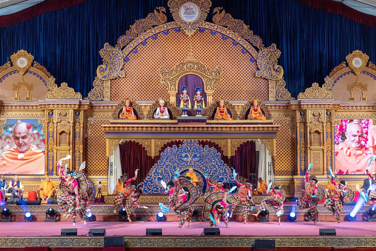 Youths perform a traditional dance in the presence of Swamishri