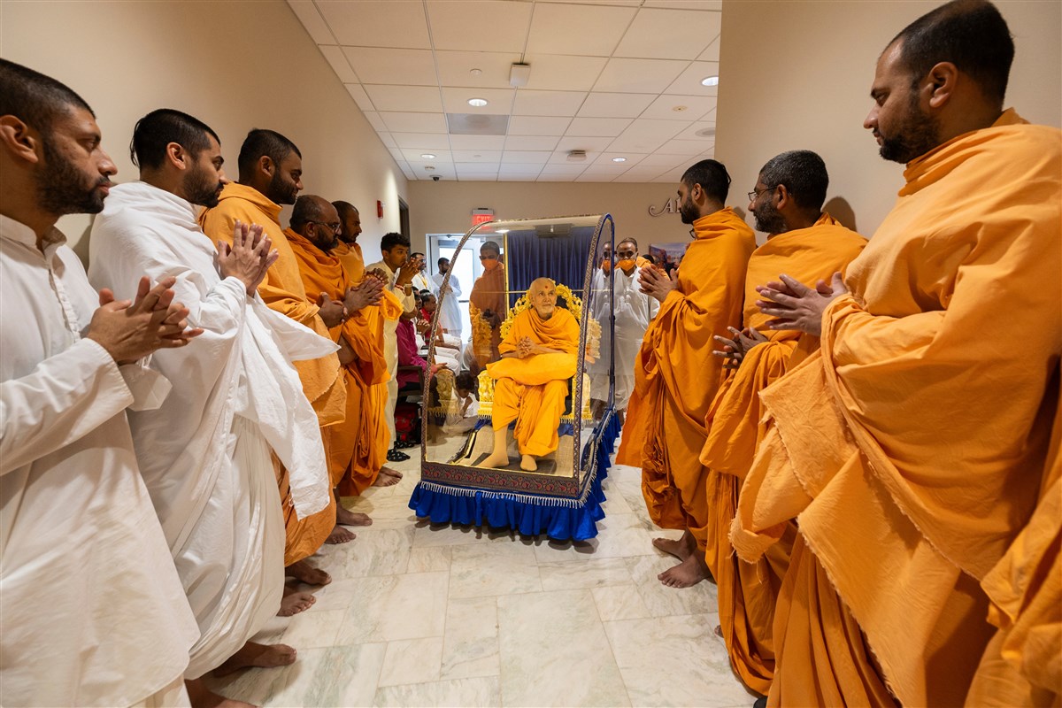 Swamishri acknowledges and greets swamis and sadhaks