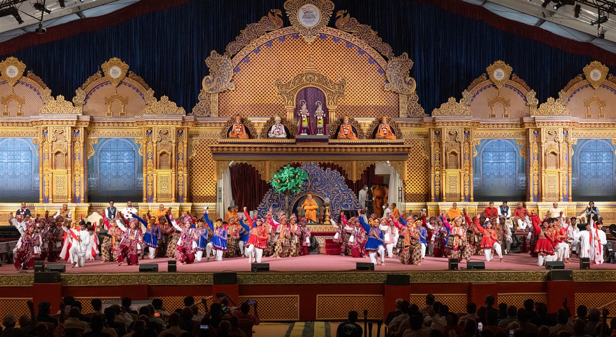 Youths jubilantly partake in a dance in the presence of Swamishri