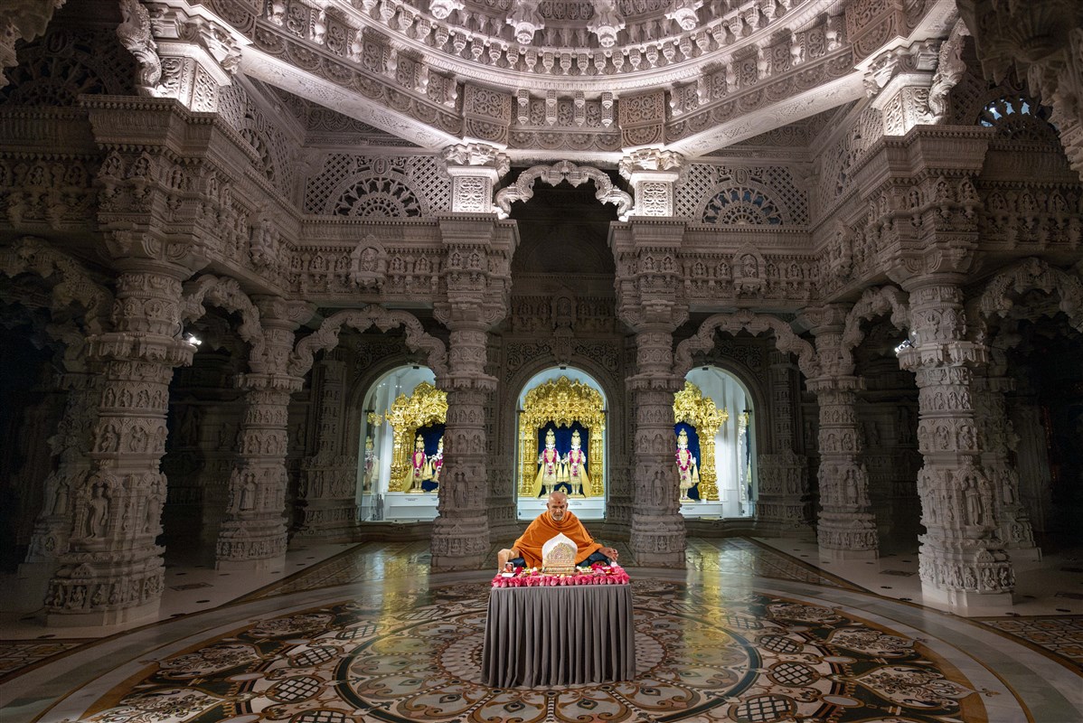 Swamishri doing puja under the mandir dome