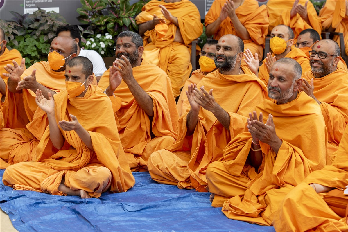 Swamis joyously clap during the kirtan bhakti