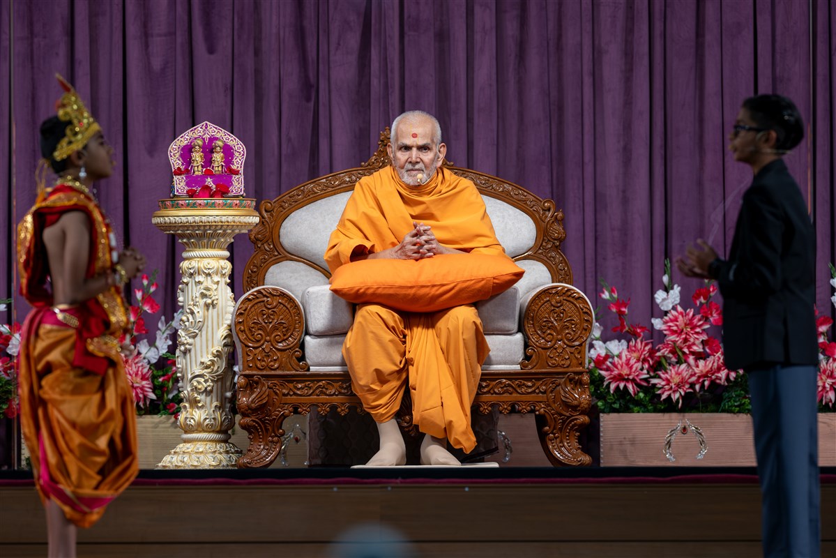 Swamishri listens to a skit performance