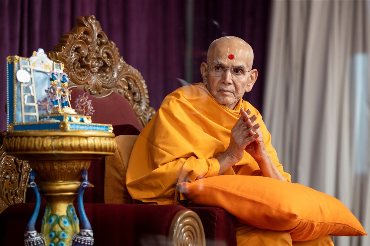 Swamishri patiently greets devotees, including those seated in corners