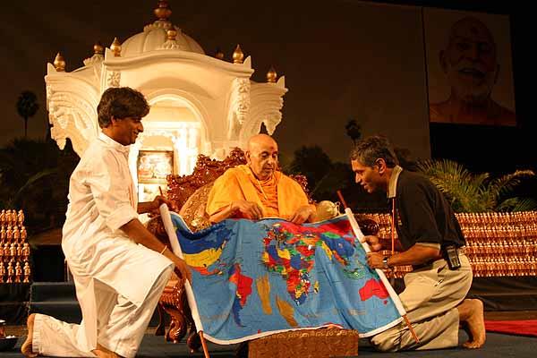 Morning,	Swamishri is presented with a map depicting his vicharan 	