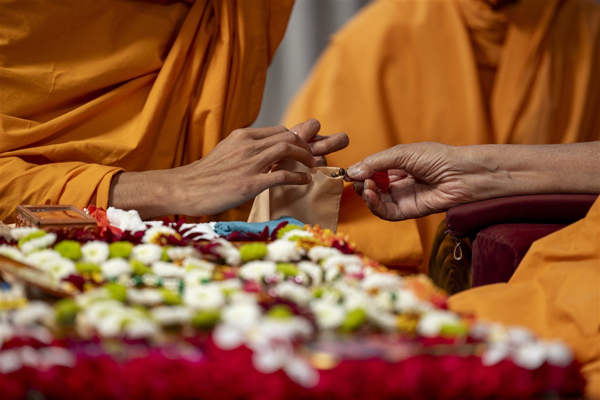 Swamishri prepares to turn the mala in his puja