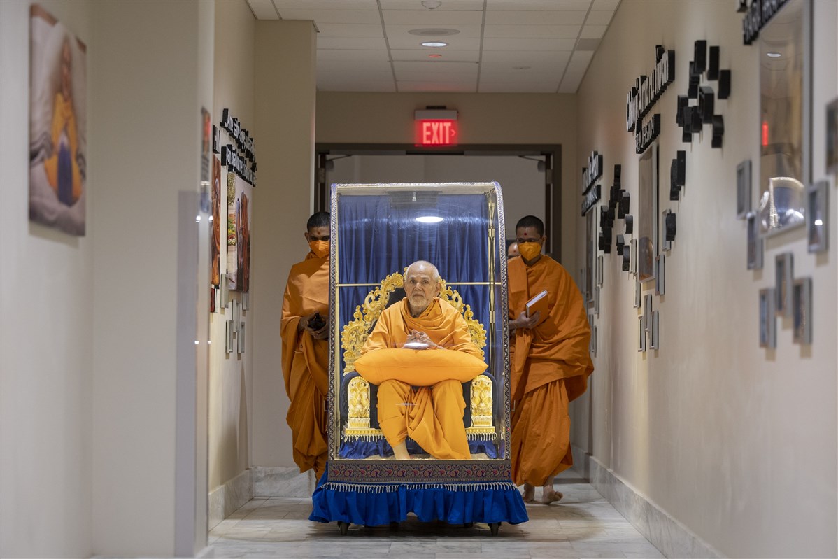 Swamishri on his way to perform his daily puja