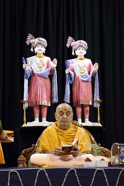 Swamishri reads the Shikshapatri at the conclusion of his morning pooja 