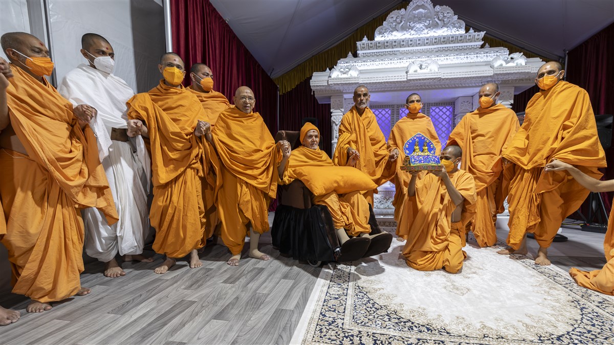 Swamishri and swamis join hands in a gesture of unity