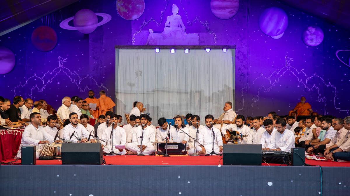 Youths sing kirtans at the beginning of the assembly