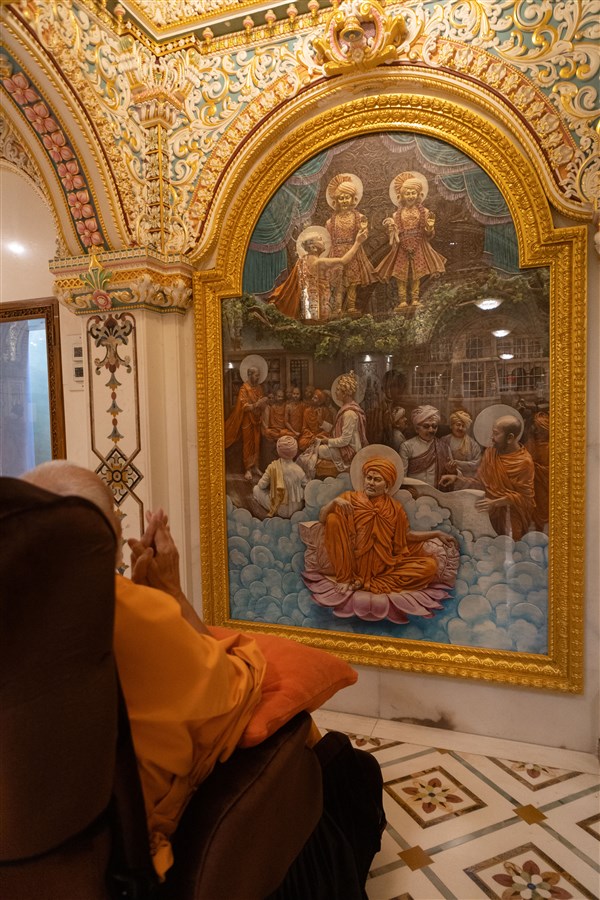Swamishri engrossed in darshan of murals in the pradakshina of the Akshar Deri