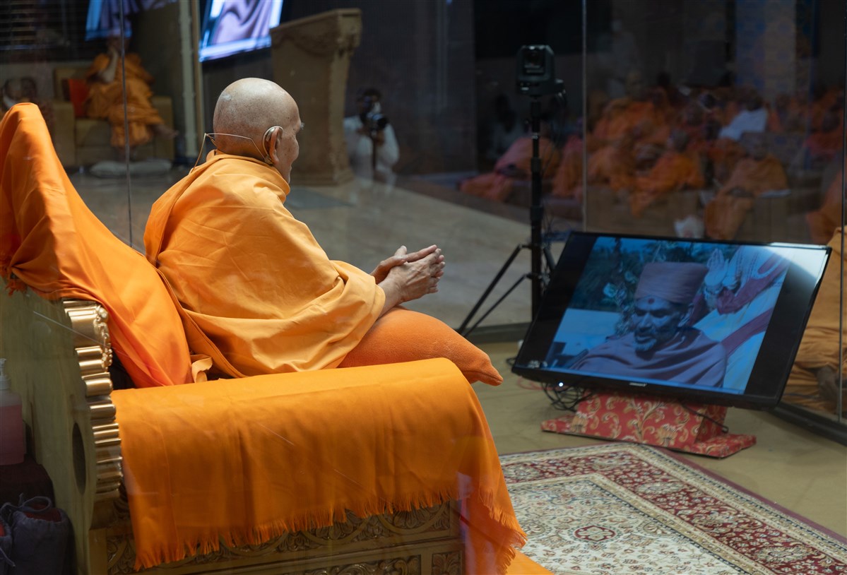 Swamishri watches a video