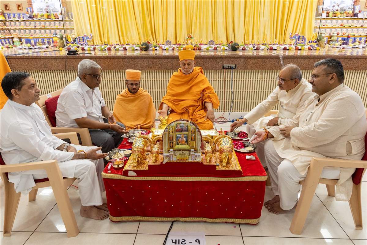 Swamis and devotees participate in mahapuja rituals
