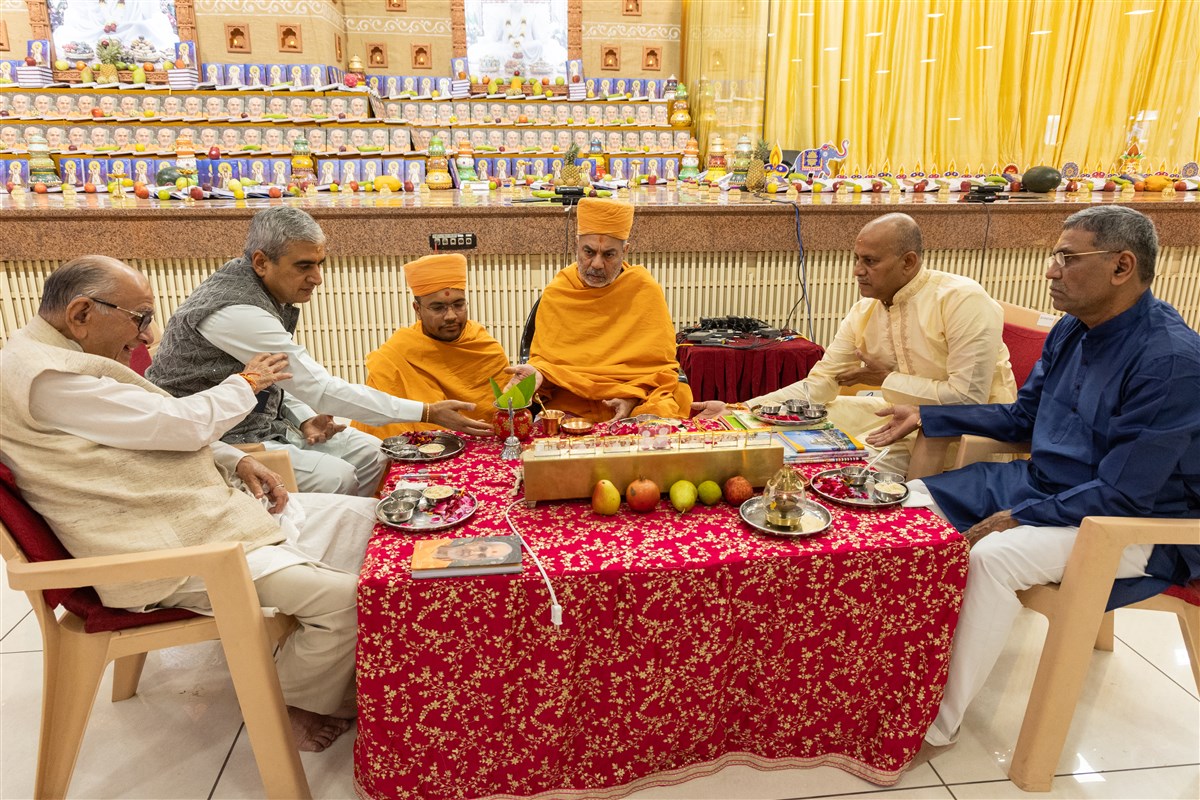 Swamis and devotees participate in mahapuja rituals