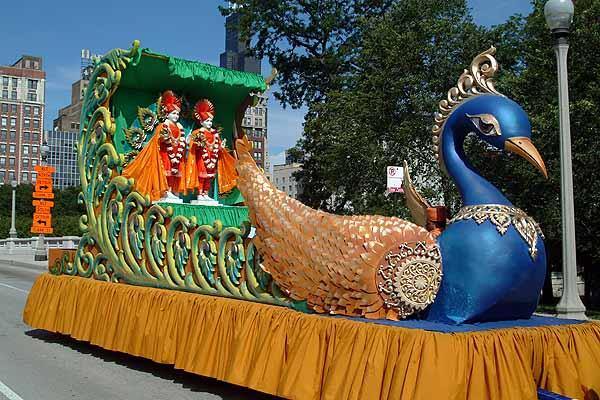 Shri Akshar Purushottam Maharaj seated on the peacock float