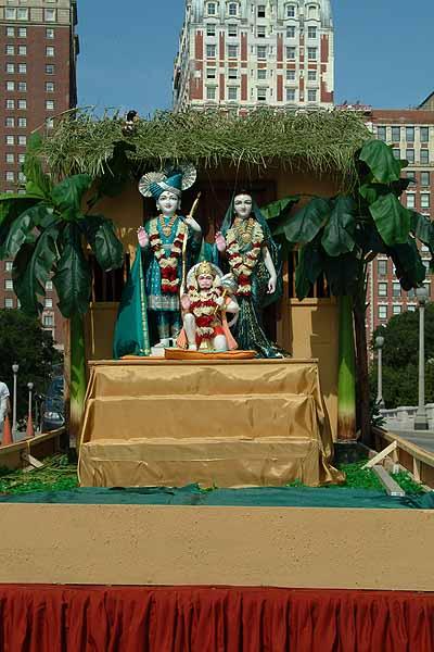 Shri Sita-Ram Dev and Hanumanji seated in a float decorated as a hut