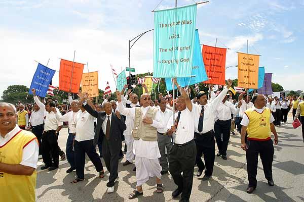 Devotees hold banners with inspirational messages