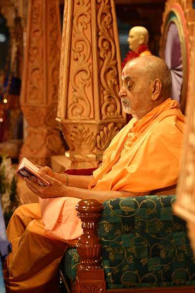 Kishori Din July 29, 2004 -  Swamishri reads verses from the Shikshapatri at the end of his puja