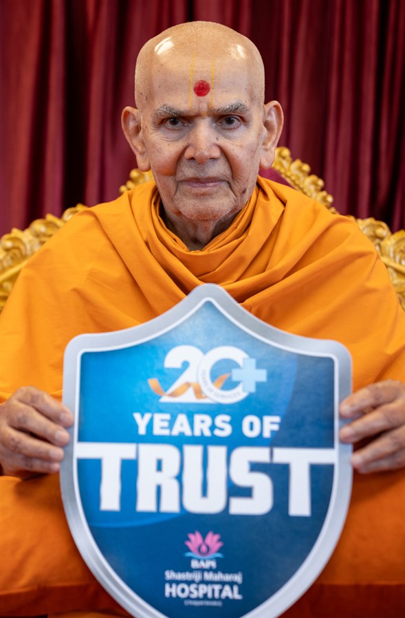 Swamishri holds a card