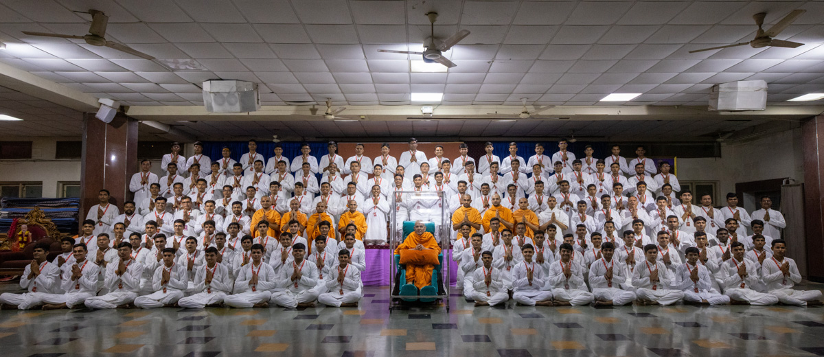 Swamis and youths with Swamishri in the evening