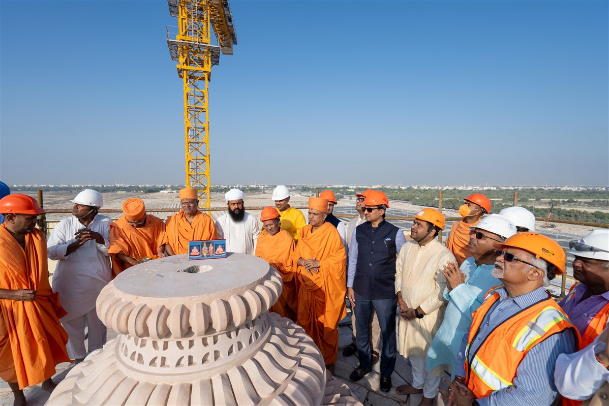 Swamis and volunteers pray for the successful placement of the Kalash and the completion of the Mandir