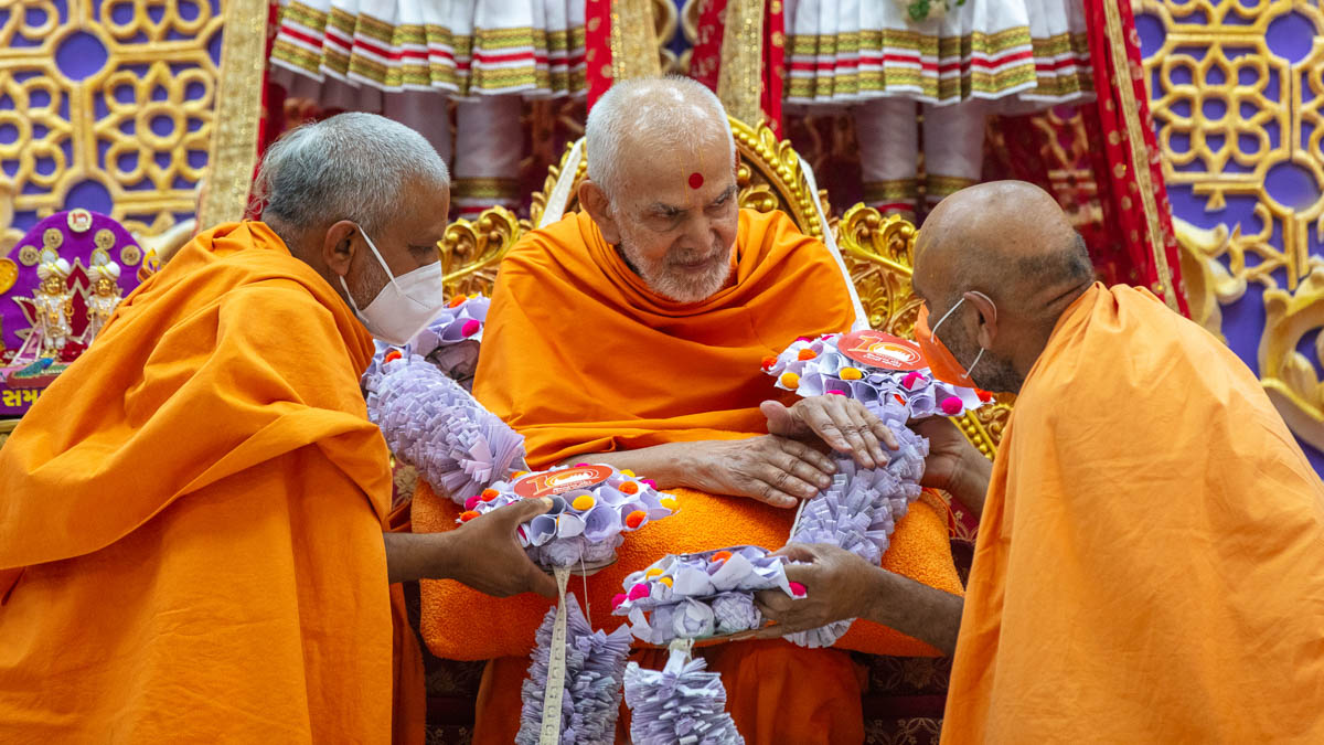 Swamis honor Swamishri with a garland